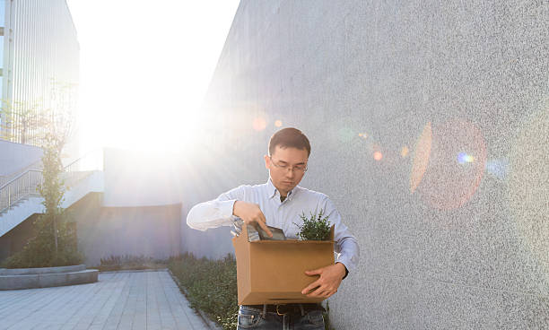 istock Unemployment man carrying box and leaving office 2221724238