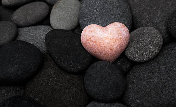 istock Pink stone heart in a stone heap 2221724441