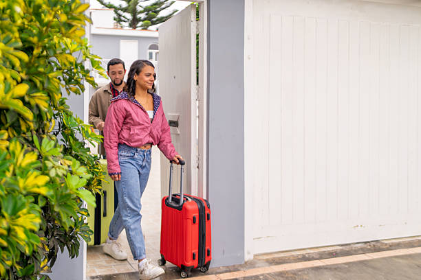 istock Couple leaving home with suitcases for a trip 2221735469