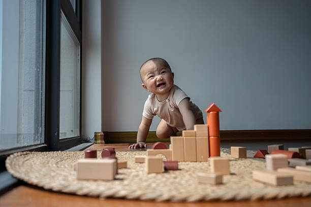 Cute baby boy is joyfully crawling on the fresh green grass, exploring the world with curiosity
