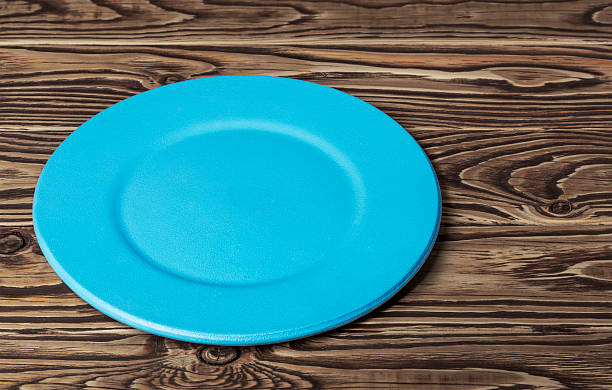 istock round empty blue plate on vintage wooden background 2221739050