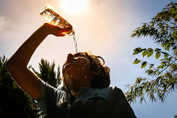 Boy refreshing himself with water under the summer sun