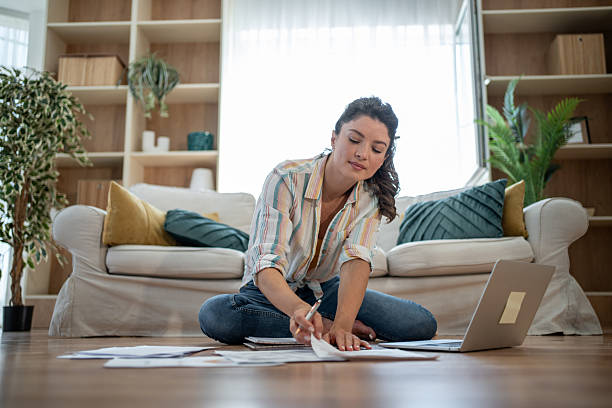 istock Focused woman reviewing documents and working from home 2221743164