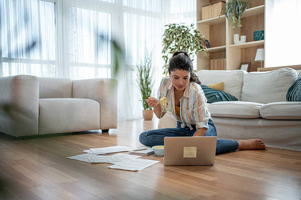 istock Freelancer working from home and eating noodles while using laptop 2221743188