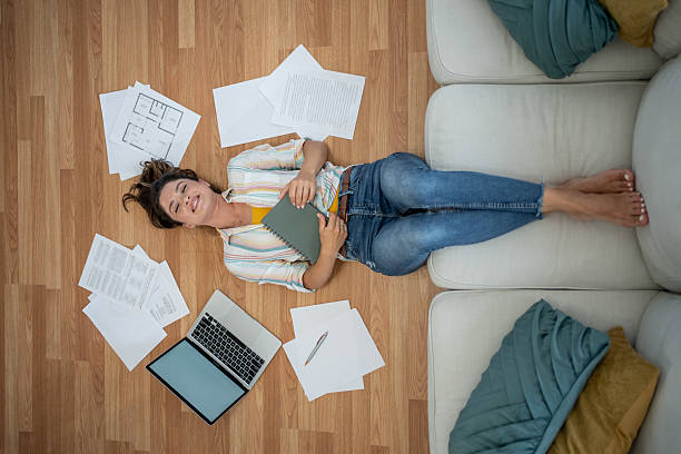 istock Young woman relaxing on floor after working from home 2221743217