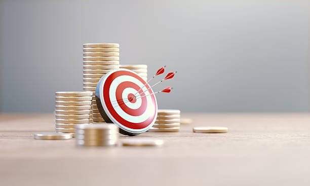 istock Red Bull's Eye Target On Coin Stacks Before Defocused Background 2221744033