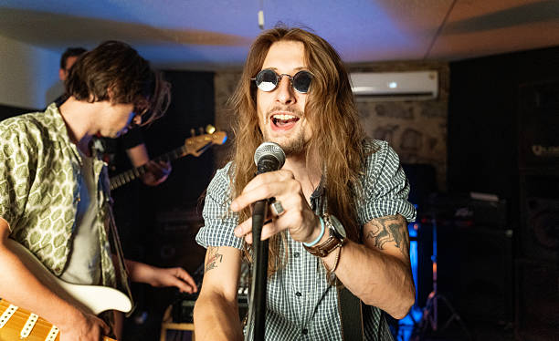 istock Energetic Lead Singer Performing With Band in a Vibrant Rehearsal Studio 2221744521