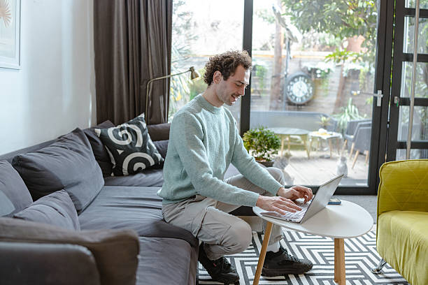 istock Man working from home on his laptop in a bright living room 2221746085