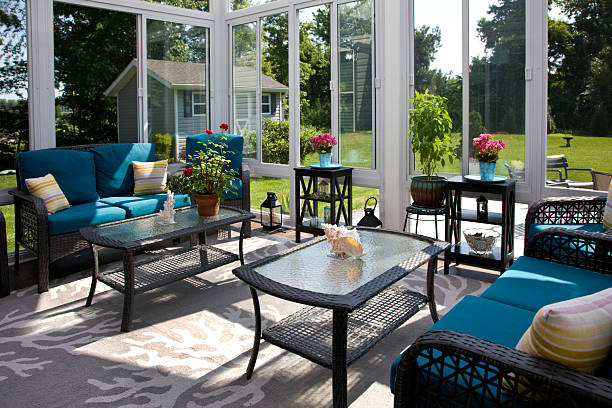 Cozy screened porch winter during Holidays season, snowy roofs and woods in the background.