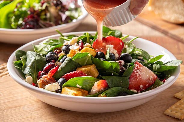 istock Berry spinach salad being served in a white bowl 2221748551