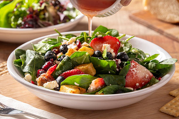 istock Berry spinach salad being served in a white bowl 2221748563