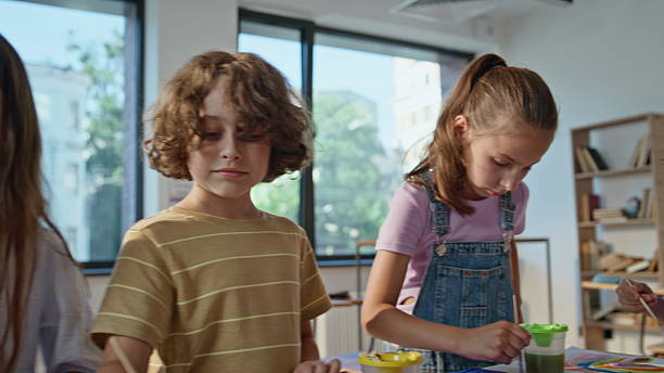 istock Creative children painting art lesson in elementary school closeup. Group pupils 2221752875