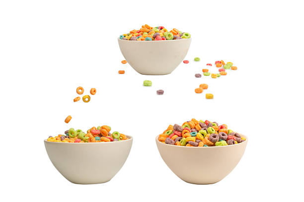 Colorful cereal box for morning breakfast. Corn flakes falling to the white bowl. Motion.