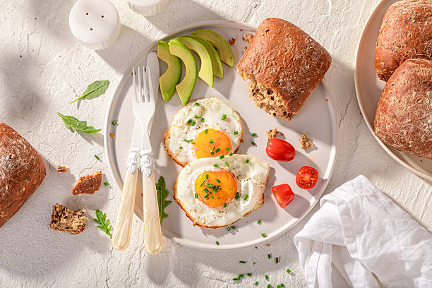 istock Healthy and fresh breakfast with buns and fried eggs. 2221755091