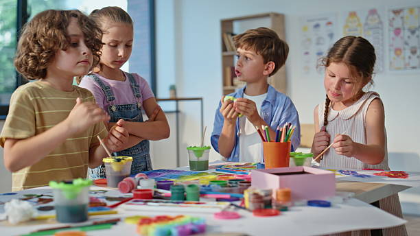 istock Children working art workshop using colorful materials on school desk closeup. 2221755543