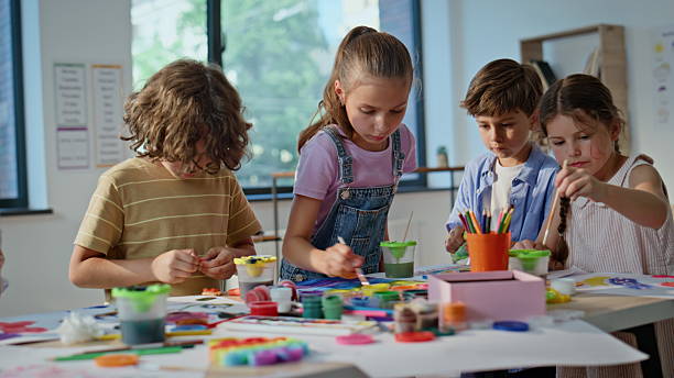 istock Kids engaged art activity at elementary school artclass closeup. Group children 2221755615