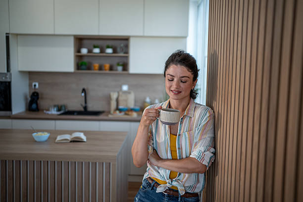 istock Serene woman enjoying morning coffee in modern kitchen 2221756695