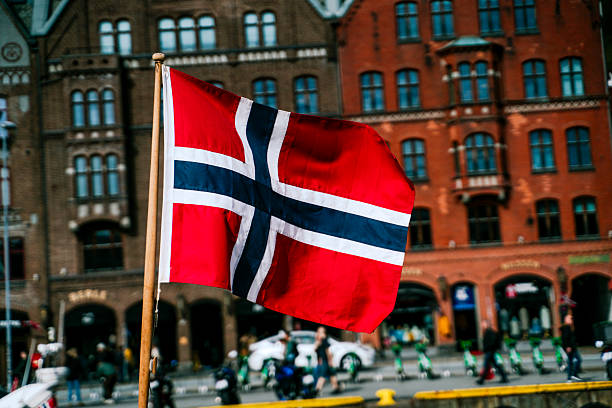 Norwegian flag in front of traditional building