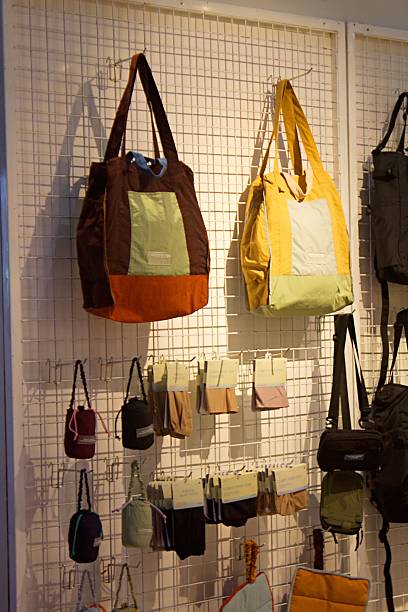 istock Colorful Tote Bags and Mini Pouches Displayed on Grid Wall 2221767457