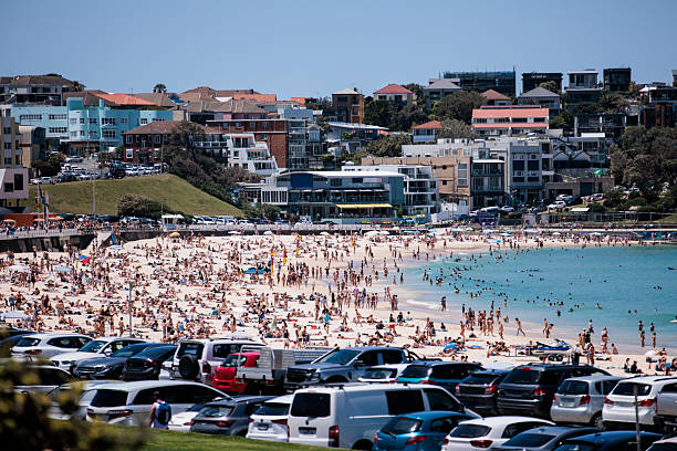 Lively Manly beach in Sydney, Australia, filled with sun-seekers enjoying the sand, surf, and sunshine.