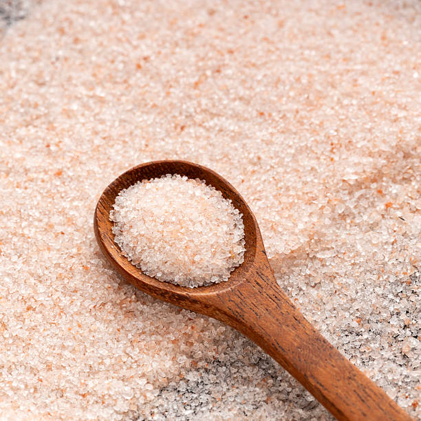 istock Fine salt and pink Himalayan crystals on the spoon. 2221771452