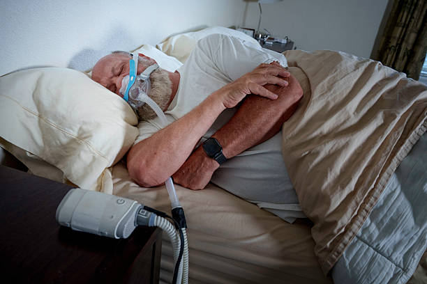 istock Respiratory support. Patient manages nighttime breathing treatment. 2221772010