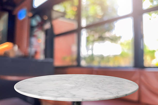 istock Round marble table top with blurred kitchen cafe restaurant interior background 2221773634