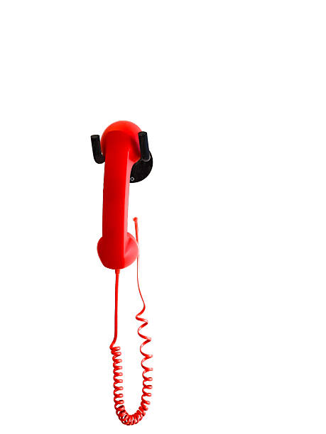 istock Red Telephone Handset Hanging on White Wall with Copy Space 2221775007