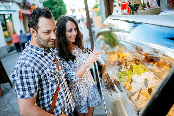 istock Couple choosing ice cream from display on sunny day 2221775052