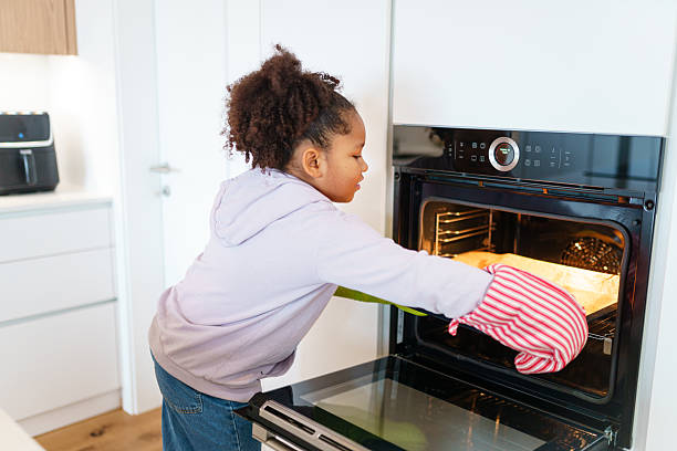 istock Young Girl Baking Cookies in a Bright Home Kitchen 2221775108