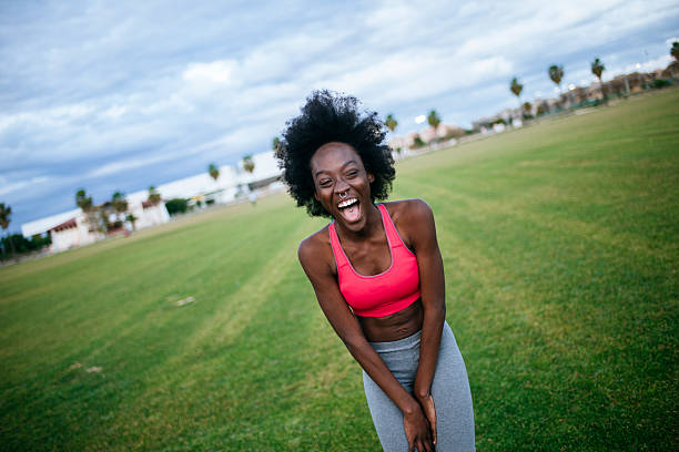 istock woman laughing while taking a break from her outdoor workout 2221775639