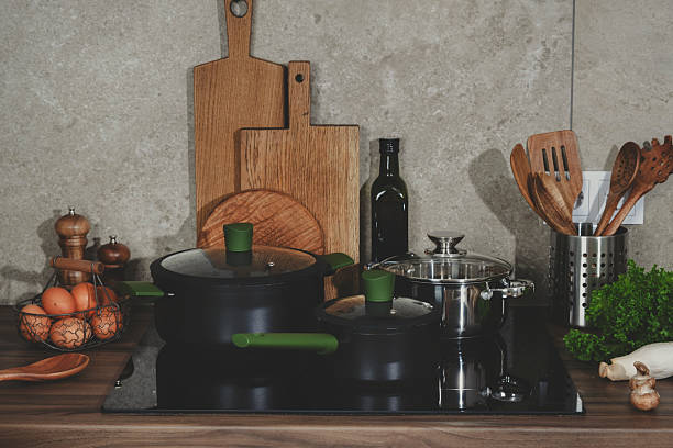 istock Beautiful kitchen with pans on oven, utensils, fresh vegetables and herbs ready for healthy cooking on the countertop, featuring farm market sourced ingredients 2221777036