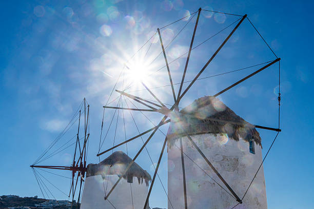 Windmills of Mykonos, Greece with a sun flair in the sky