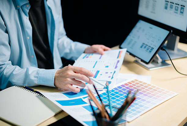 istock Asian UX,UI designer reviewing app wireframes and color samples in modern office. Creative process, web design 2221784314