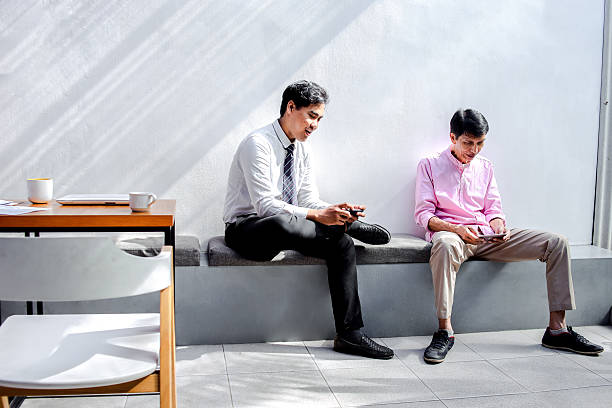 istock Old and Young Businesspeople in Office Break 2221786119