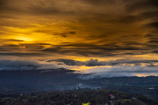Scenic view dramatic beautiful sunset sky. Natural Sunset Sunrise on meadow silhouette shadow dark land. Vibrant dramatic sky on sunset, dawn, sunrise in Countryside. Landscape Colorful Sky At Sunset