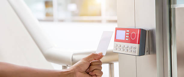 istock Proximity card reader door unlock, Close up hand security man using ID card scanning at the access control system for identity verification to open the door or for security safety or check attendance. 2221787764