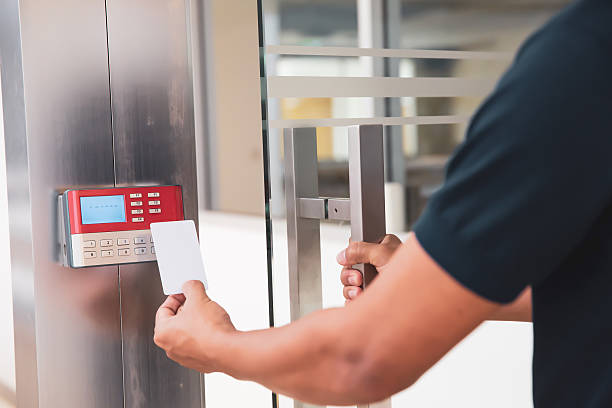 istock Proximity card reader door unlock, Close up hand security man using ID card scanning at the access control system for identity verification to open the door or for security safety or check attendance. 2221787766