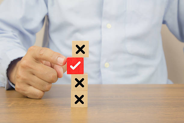 istock Hand choose check mark on wooden toy with cross symbol for true or false changing mindset or way of adapting to change leader and transform quiz answer and poll concept. 2221788169