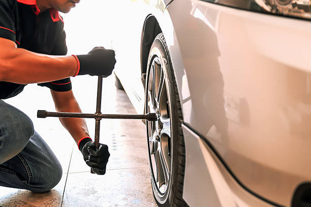 istock Car care maintenance and servicing, Close-up hand technician auto mechanic using wrench change tire concept of repairing and fix car problem and insurance service support. 2221788240