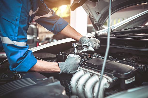 Car care maintenance and servicing, Close-up hand technician auto mechanic using the wrench to repairing change spare part car engine problem and car insurance service support.