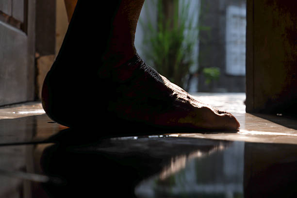 Close up of barefoot woman.