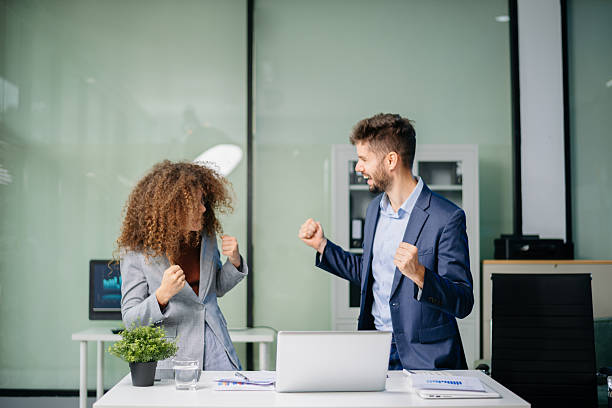istock Happy business team cheering in office after project success. Celebration, teamwork victory, achievement 2221793081
