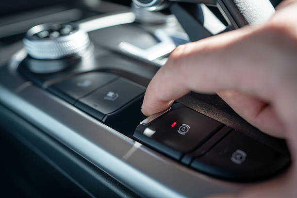 istock Person Activating Vehicle Electronic Parking Brake Control Button in a Modern Car Interior 2221793418