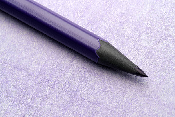 A vibrant purple pencil rests on soft, textured paper, inviting creativity.