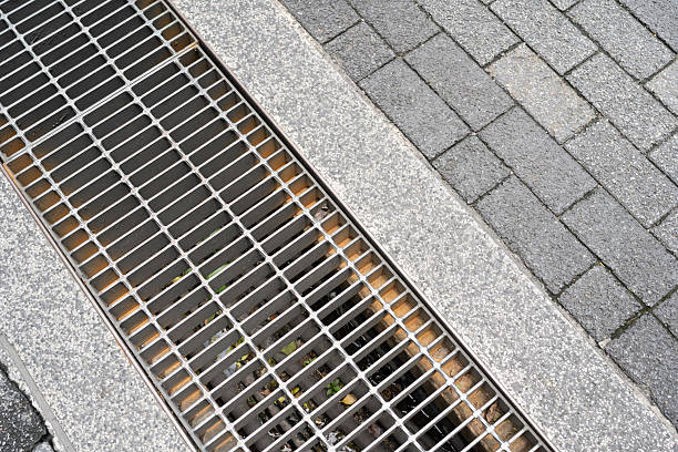 istock Urban Drainage Grate and Paving Stones. 2221801499