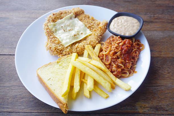 Chicken steak with spaghetti and chips in white dish