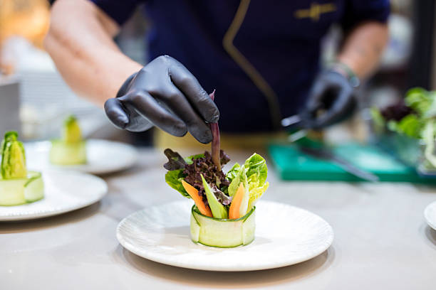 istock Male Cook preparing salad plates in a luxury restaurant kitchen 2221803188