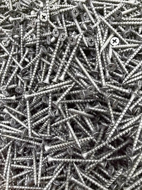istock Screws scattered on a workshop floor create a striking metallic landscape 2221803287