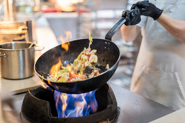 istock Chef preparing food in restaurant kitchen 2221804149